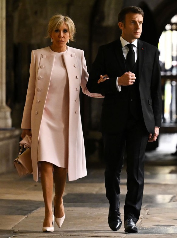 LONDON, ENGLAND - MAY 06: French President Emmanuel Macron and his wife Brigitte Macron arrive to take their seats ahead of the Coronation of King Charles III and Queen Camilla on May 6, 2023 in Londo ...