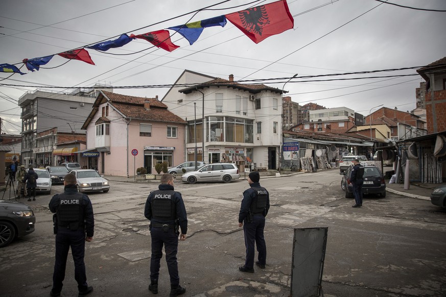 Kosovo police officers patrol in a mixed community neighborhood in ethnically divided town of northern Mitrovica on Friday, Dec. 9, 2022. Kosovo law enforcement on Friday said one officer was injured  ...