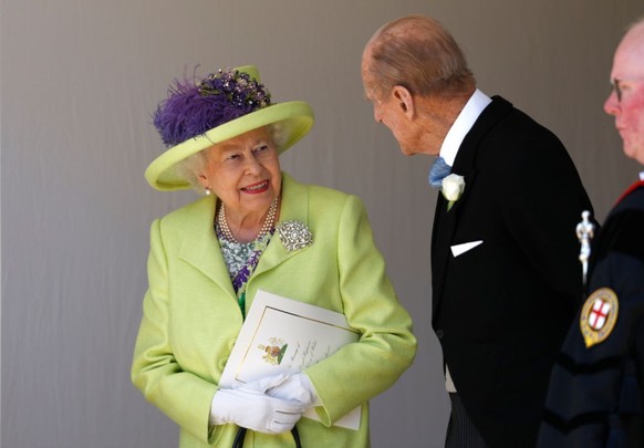 Queen Elizabeth II talks with the Duke of Edinburgh after the wedding ceremony of Prince Harry and Meghan Markle at St. George&#039;s Chapel in Windsor Castle. (Photo by Alastair Grant/PA Images via G ...