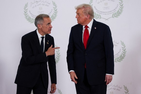 President Donald Trump and Canadian Prime Minister Mark Carney, left, speak as they pose for a photo at a world leaders&#039; summit on ending the Gaza war, in Sharm el-Sheikh, Egypt, Monday, Oct. 13, ...