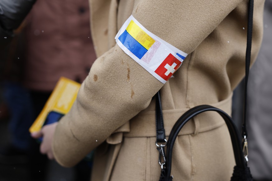 Ukrainian politician Maria Mezentseva wears a sticker with the Swiss and Ukrainian flag, during a national demonstration against the Russian invasion of Ukraine in Bern, Switzerland, Saturday, April 2 ...
