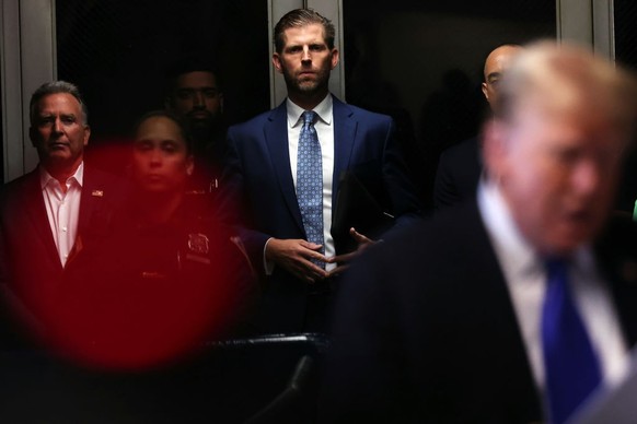 NEW YORK, NEW YORK - MAY 30: Eric Trump listens as his father former U.S. President Donald Trump speaks as he arrives for his hush money trial at Manhattan Criminal Court on May 30, 2024 in New York C ...