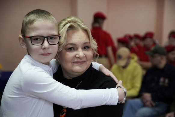 Schoolboy Ivan Ilyin, 7, and his mother Alyona pose during a ceremony led by local patriotic movements to reward him for the drawings, messages and gifts he sent to Russian soldiers taking part in the ...