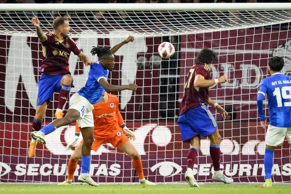 Servette&#039;s defender Steve Rouiller (L) scores the 1-1 during the UEFA Champions League Second qualifying round first leg soccer match between Switzerland&#039;s Servette FC and Belgium&#039;s KRC ...