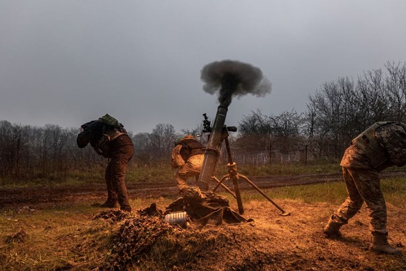 DONETSK OBLAST, UKRAINE - APRIL 20: Ukrainian soldiers of the 57th Brigade fire a mortar in the direction of Bakhmut, in Donetsk Oblast, Ukraine on April 20, 2023. (Photo by Diego Herrera Carcedo/Anad ...