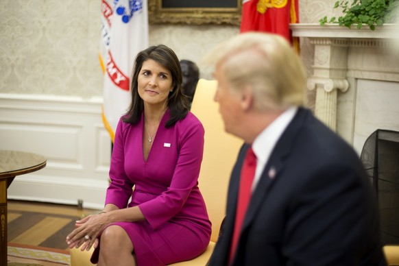 epa07081172 US Ambassador to the United Nations Nikki Haley (L) listens to US President Donald J. Trump (R) deliver remarks to members of the news media in the Oval Office of the White House in Washin ...