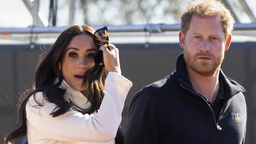 FILE - Prince Harry and Meghan Markle, Duke and Duchess of Sussex visit the track and field event at the Invictus Games in The Hague, Netherlands, Sunday, April 17, 2022. Prince Harry and his wife, Me ...