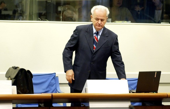 Former Yugoslav President Slobodan Milosevic enters a court room of the war crimes tribunal in The Hague, Tuesday Aug 31, 2004. Milosevic opened his defense case at the Yugoslav war crimes tribunal Tu ...