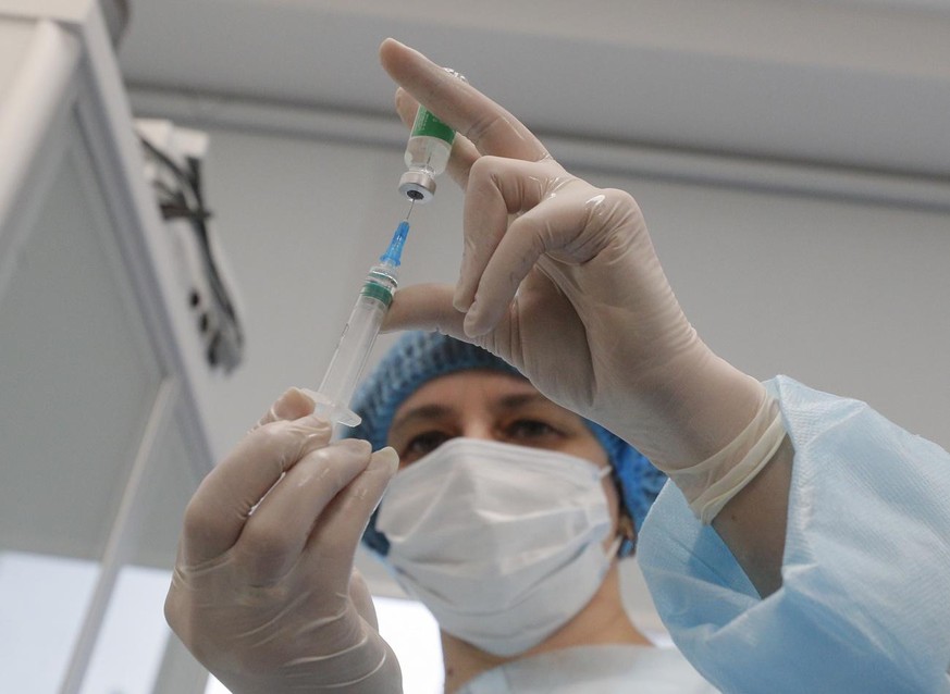 epa09053675 A medical worker prepares the AstraZeneca (Covishield) vaccine injection in Kiev, Ukraine, 05 March 2021. The mobile medical team of the Ministry of Health of Ukraine publicly vaccinated a ...