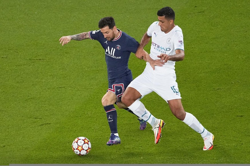 PSG&#039;s Lionel Messi, left, and Manchester City&#039;s Rodrigo battle for the ball during the Champions League Group A soccer match between Paris Saint-Germain and Manchester City at the Parc des P ...