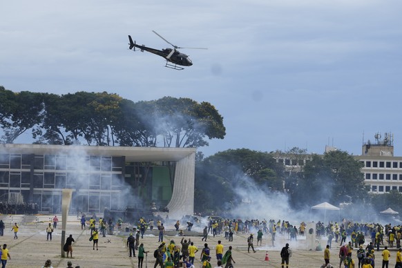 FILE - Supporters of Brazil&#039;s former President Jair Bolsonaro clash with police as they storm the Planalto presidential palace, the official workplace of the president, in Brasilia, Brazil, Jan.  ...
