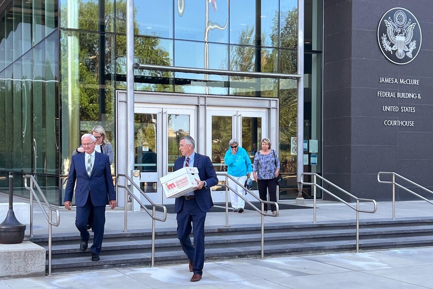 Attorneys Monte Stewart, left, and Daniel Bower, center, leave the James A. McClure Federal Building and Courthouse in Boise, Idaho, after oral arguments in a lawsuit brought by the U.S. Department of ...