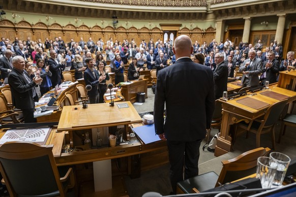 Die Mitglieder der Grossen Kammer applaudieren am Ende der Sitzung fuer Bundespraesident Alain Berset, Mitte, der seinen voraussichtlich letzten Auftritt im Nationalrat hatte, auf den Tag genau 12 Jah ...