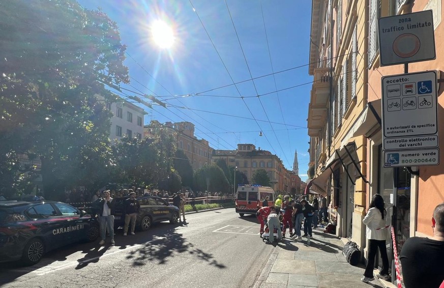 epa12964848 Law enforcement and emergency personnel work at the scene after a vehicle struck several pedestrians in downtown Modena, northern Italy, 16 May 2026. According to Modena Mayor Massimo Mezz ...