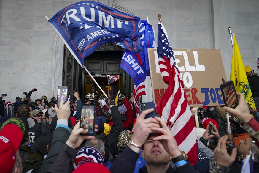 FILE - In this Jan. 6, 2021, file photo insurrections loyal to President Donald Trump riot outside the Capitol in Washington. The House panel investigation of the riot at the U.S. Capitol issued sweep ...