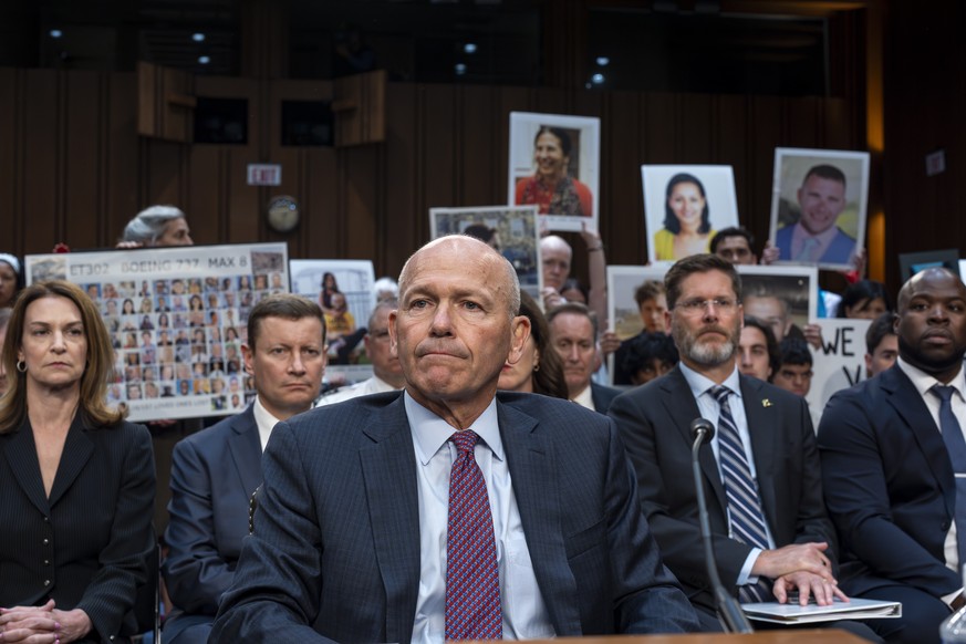 With protesters in the audience, Boeing CEO Dave Calhoun takes his seat to testify before the Senate Homeland Security and Governmental Affairs Subcommittee on Investigations to answer to lawmakers ab ...