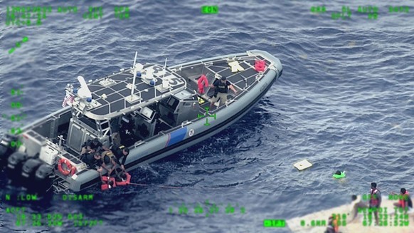 epa09943656 A handout photo made available by US Customs and Border Protection shows US Coast Guard air and surfaces rescue crews, Customs and Border Protection law enforcement boat crews and partner  ...