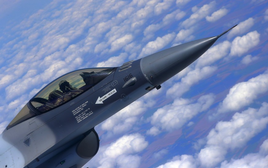 epa09318477 A F16 Fighting Falcon jet fighter of the Romanian Air Force, intercepts a &#039;hostile&#039; airplane during a NATO Reinforce Air Police Exercise held in the airspace above the internatio ...