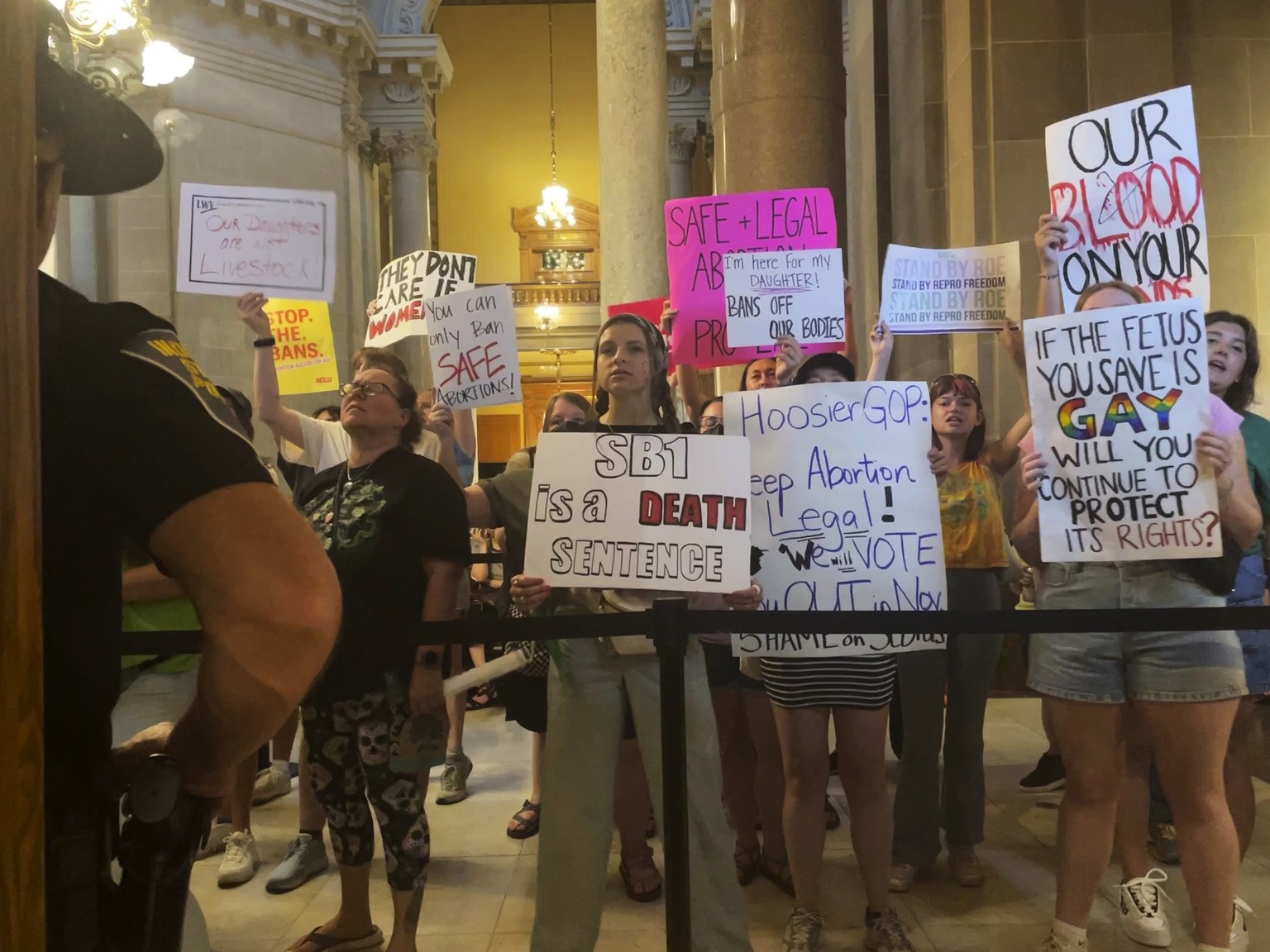 Abortion-rights protesters fill Indiana Statehouse corridors and cheer outside legislative chambers, Friday, Aug. 5, 2022, as lawmakers vote to concur on a near-total abortion ban, in Indianapolis. (A ...