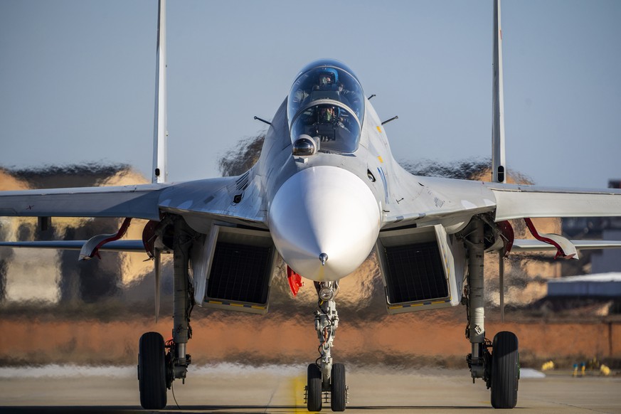 FILE - Main China pilots prepare to fly a J-16 fighter jet at a training base for China&#039;s People&#039;s Liberation Army (PLA) naval aviation force in Ningbo in eastern China&#039;s Zhejiang Provi ...