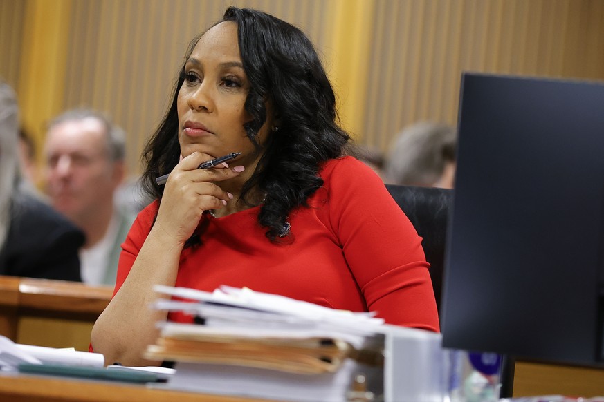 FILE - Fulton County District Attorney Fani Willis looks on during a hearing on the Georgia election interference case, Friday, March, 1, 2024, in Atlanta. On Wednesday, March 6, Ashleigh Merchant, th ...