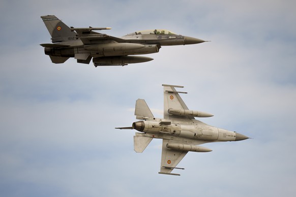 Romanian air force F-16 fighter planes fly above the Baza 86 military air base, outside Fetesti, Romania, Monday, Nov. 13, 2023. NATO member Romania inaugurated an international training hub for F-16  ...