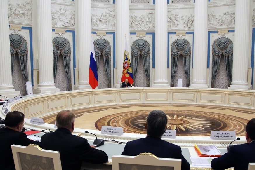 Russian President Vladimir Putin, background center, chairs a meeting of leadership of military-industrial complex enterprises at the Kremlin in Moscow, Russia, Tuesday, Sept. 20, 2022.