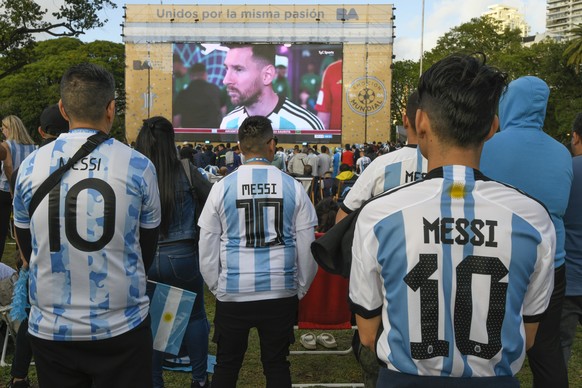 Argentina soccer fans wearing Lionel Messi jerseys watch their team lose to Saudi Arabia in a World Cup Group C soccer match, played on a large screen in the Palermo neighborhood of Buenos, Aires, Arg ...