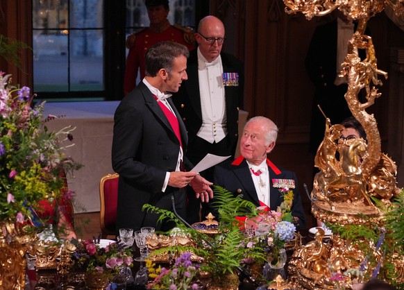 WINDSOR, ENGLAND - JULY 8: King Charles III (R) looks on as French President Emmanuel Macron speaks at a state banquet on July 8, 2025 in Windsor, England. Macron and wife Brigitte Macron are visiting ...