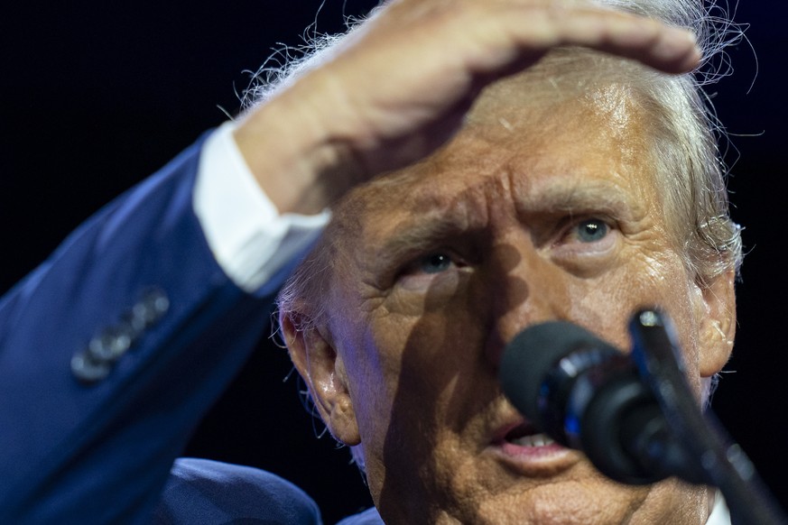 Former President Donald Trump shields his eyes to see the crowd as he speaks at the Conservative Political Action Conference, CPAC 2023, Saturday, March 4, 2023, at National Harbor in Oxon Hill, Md. ( ...