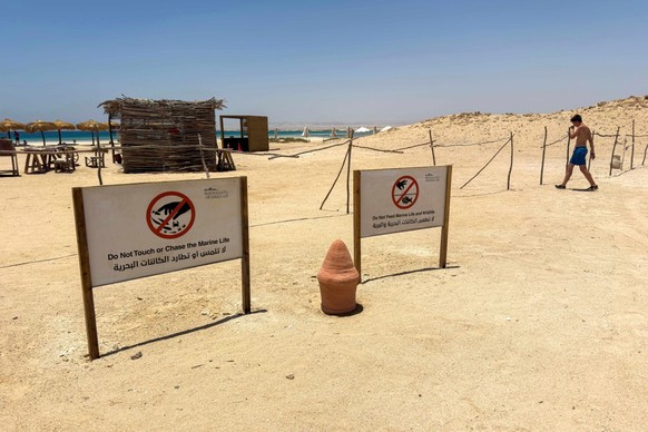 (FILES) Signs urge visitors to respect wildlife at the Ras Hankorab beach in the Red Sea Wadi Al-Gemal protectorate in southern Egypt on May 28, 2025. Wadi al-Gemal National Park, declared a protected ...