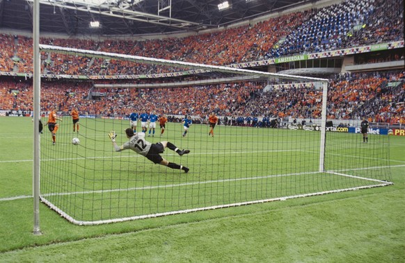 Italy footballer Francesco Toldo dives to save the penalty of Dutch footballer Frank de Boer, the Netherlands' first of the penalty shootout of the UEFA Euro 2000 semifinal between Italy and the  ...