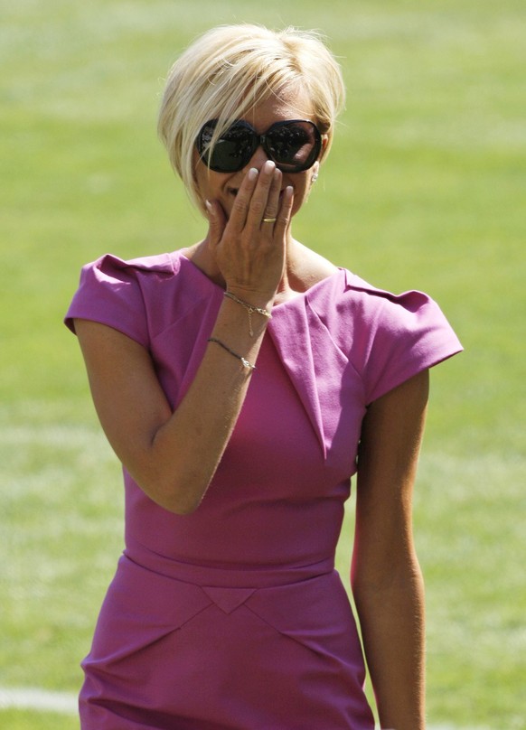 Victoria Beckham reacts to the fans as she arrives at the news conference to introduce her husband, England soccer star David Beckham, as the newest member of the Los Angeles Galaxy soccer team at the ...