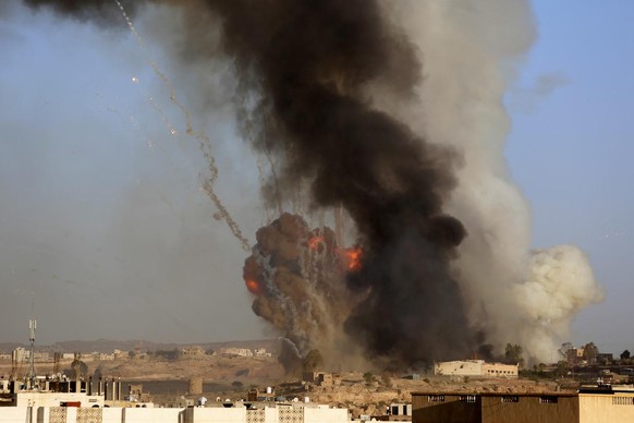 An explosion and smoke rise after an airstrike by the Saudi-led coalition at a weapons depot in Sanaa, Yemen, Friday, Sept. 11, 2015. Saudi Arabia is leading a coalition of mainly Gulf nations fightin ...