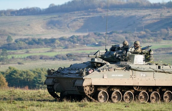 SALISBURY, ENGLAND - NOVEMBER 23: Prince William, Prince of Wales, Colonel-in-Chief, 1st Battalion Mercian Regiment (L) listens to a briefing ahead of an attack exercise during a visit to the regiment ...