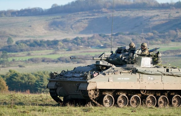 SALISBURY, ENGLAND - NOVEMBER 23: Prince William, Prince of Wales, Colonel-in-Chief, 1st Battalion Mercian Regiment (L) listens to a briefing ahead of an attack exercise during a visit to the regiment ...