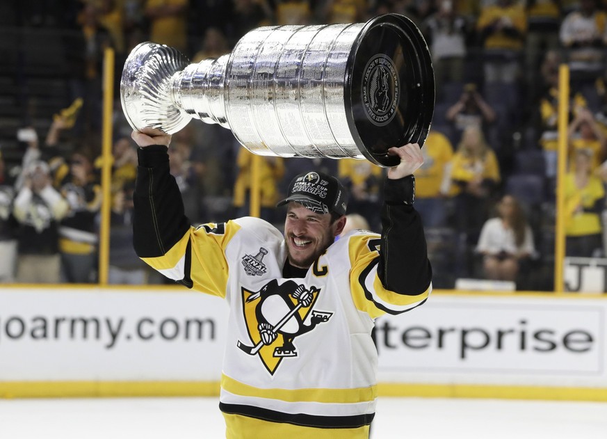 Pittsburgh Penguins' Sidney Crosby (87) celebrates with the Stanley Cup after defeating the Nashville Predators in Game 6 of the NHL hockey Stanley Cup Final, Sunday, June 11, 2017, in Nashville, ...