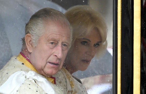 LONDON, ENGLAND - MAY 06: King Charles and Queen Camilla arrive in the Diamond Jubilee State Coach from Buckingham Palace to Westminster Abbey to the Coronation of King Charles III and Queen Camilla o ...