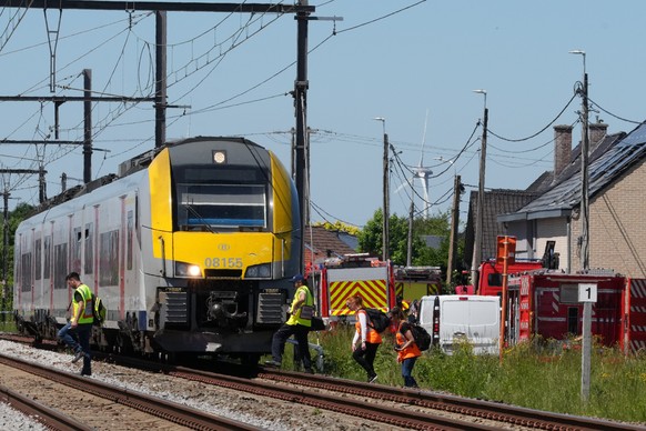 Police and rescue personal work around a level crossing where a train collided with a van in Buggenhout, Belgium, Tuesday, May 26, 2026. (AP Photo/Marius Burgelman)
Belgium Crash