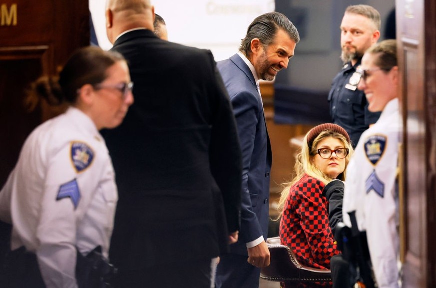 NEW YORK, NEW YORK - NOVEMBER 13: Donald Trump Jr. stops to look at a courtroom sketch as he returns from a break during his civil fraud trial at New York State Supreme Court on November 13, 2023 in N ...