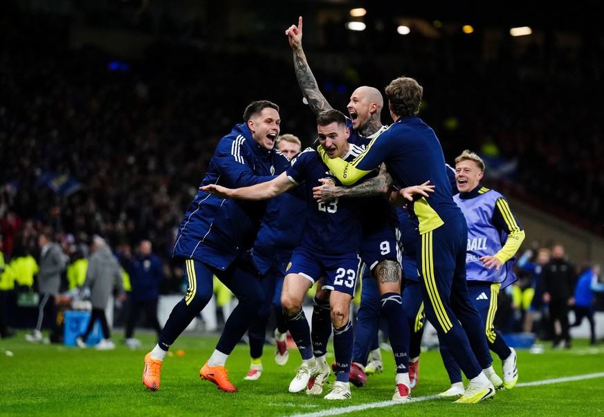 Scotland&#039;s Kenny McLean, center, celebrates with teammates after scoring their fourth goal in the 2026 World Cup European Qualifying soccer match between Scotland and Denmark at Hampden Park, Gla ...