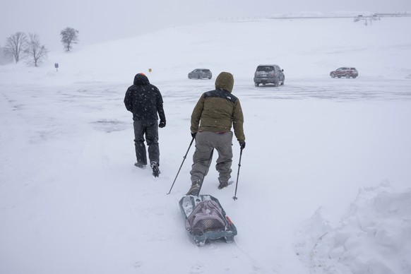 Pedestrians make their way through blowing snow as a winter storm continues to batter Halifax, Nova Scotia, on Sunday, Feb. 4, 2024. Environment Canada has maintained weather alerts across Nova Scotia ...