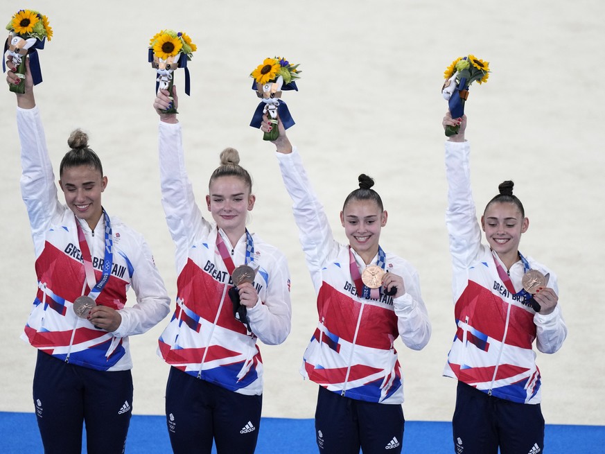 Team Britain, comprising of Jennifer Gadirova, Jessica Gadirova, Alice Kinsella and Amelie Morgan, celebrate after winning bronze in the artistic women&#039;s team pose after winning the bronze medal  ...