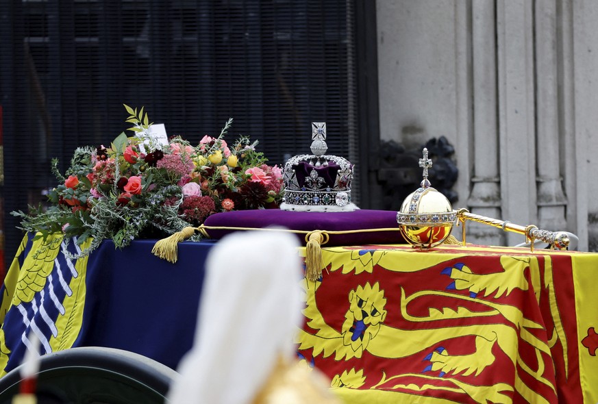 The coffin of Britain&#039;s Queen Elizabeth II is carried in the procession to Westminster Abbey for her funeral, in London, Sept. 19, 2022. (Sarah Meyssonnier/Pool Photo via AP)