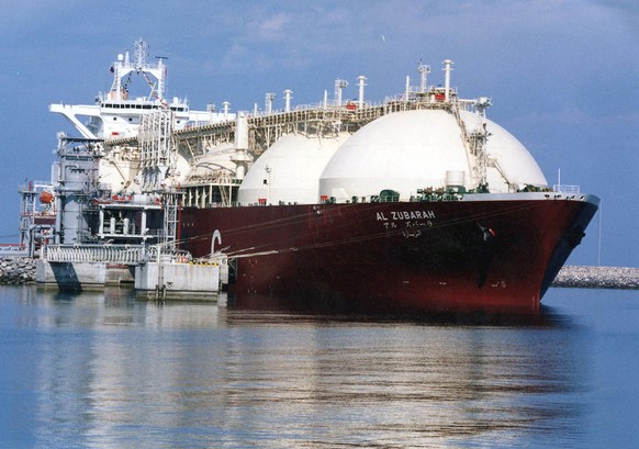 FILE - This undated file photo shows a Qatari liquid natural gas (LNG) tanker ship being loaded up with LNG, made up mainly of methane, at Raslaffans Sea Port, northern Qatar. The state-owned oil and  ...