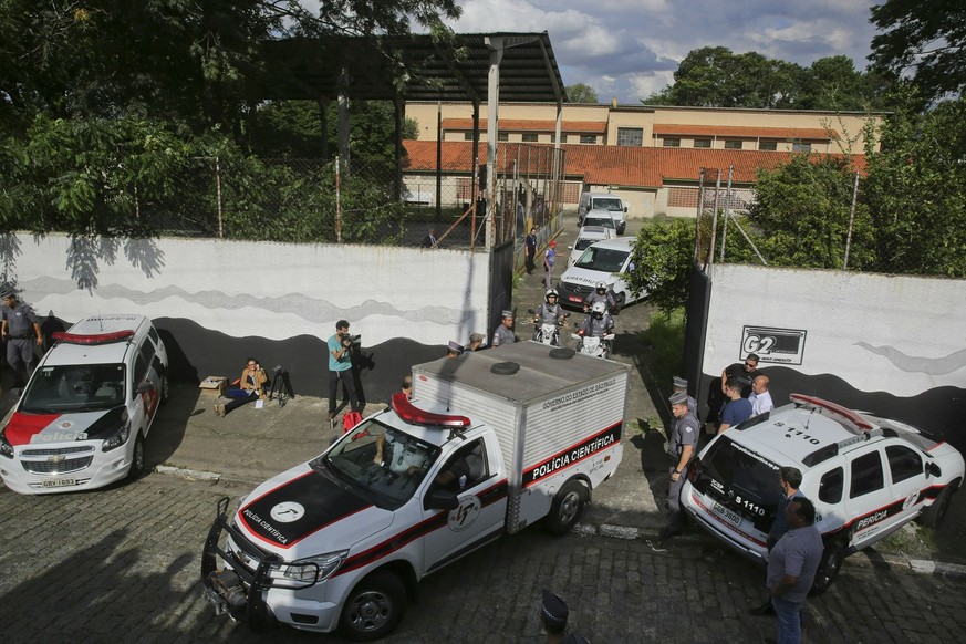 A fleet of funeral vans transport the bodies of the people who were killed in a school shooting at the Raul Brasil State School in Suzano, Brazil, on Wednesday, March 13, 2019. Two masked former stude ...