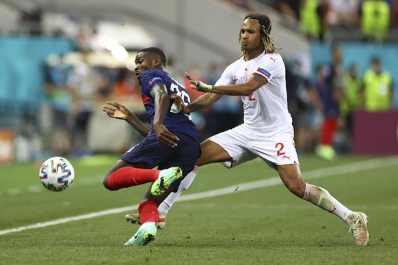 France&#039;s Marcus Thuram, left, is challenged by Switzerland&#039;s Kevin Mbabu during the Euro 2020 soccer championship round of 16 match between France and Switzerland at the National Arena stadi ...