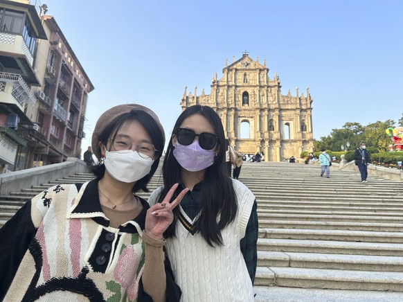 Beijing tourists Xylia Zhang, left, and Charline Zeng pose for a photo as they visit Macao for a five-day trip in Macao on Dec. 28, 2022. Zhang, taking her first trip outside the mainland since the pa ...