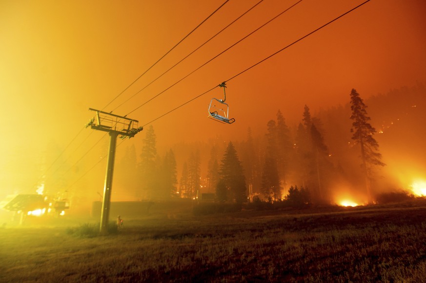 Seen in a long camera exposure, the Caldor Fire burns at the Sierra-at-Tahoe ski resort on Sunday, Aug. 29, 2021, in Eldorado National Forest, Calif. The main buildings at the ski slope&#039;s base su ...