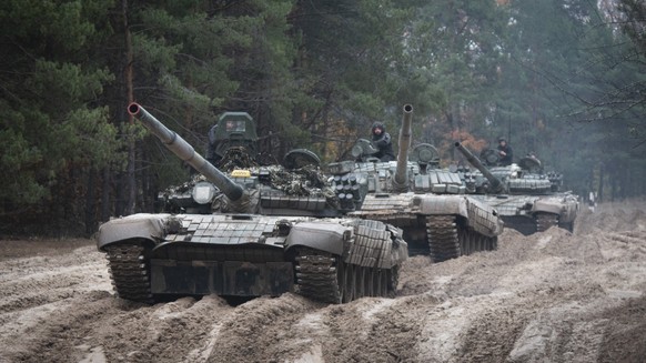 FILE - Ukrainian soldiers on captured Russian tanks T-72 hold military training close to the Ukraine-Belarus border near Chernihiv, Ukraine, Friday, Oct. 28, 2022. (AP Photo/Aleksandr Shulman, File)